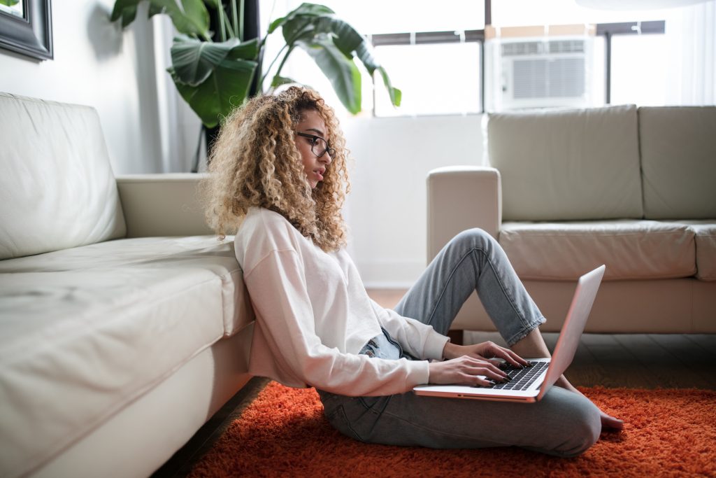 girl sitting on the floor using laptop