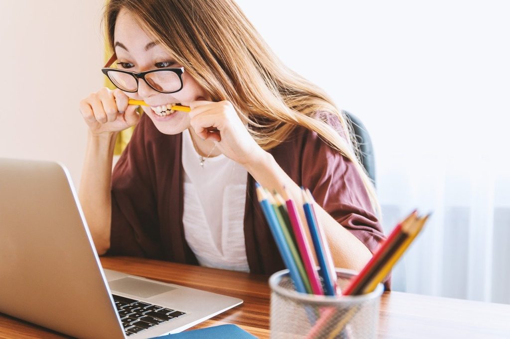 nervous girl working on laptop