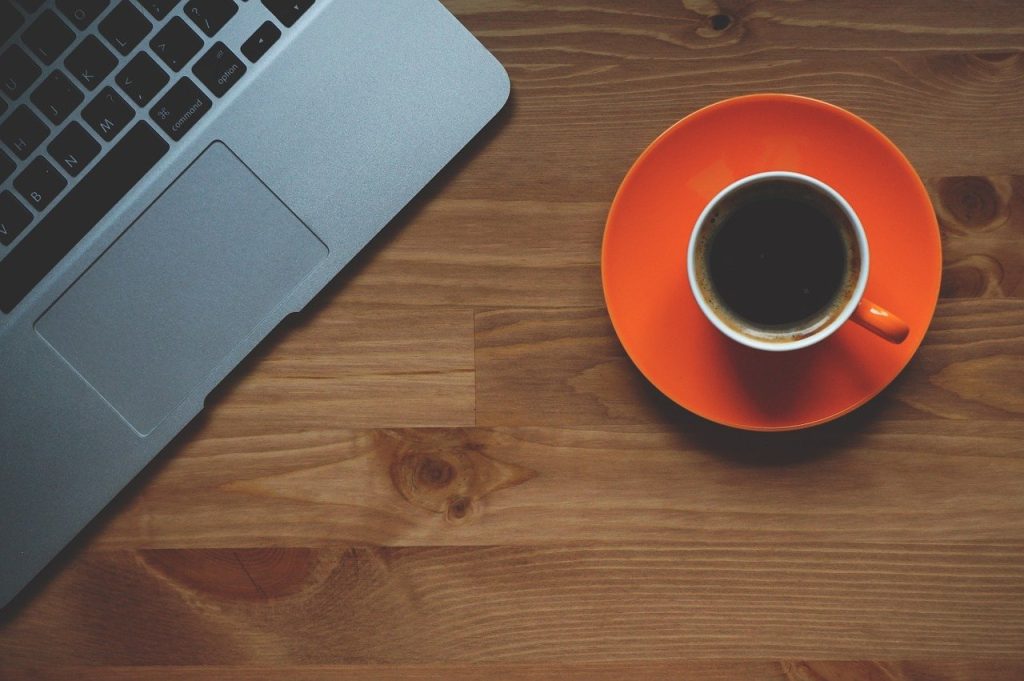 red coffee cup on wooden table