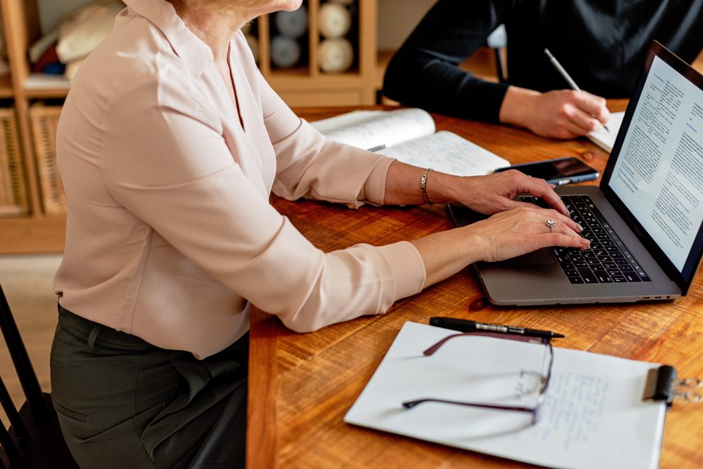 woman typing on her laptop